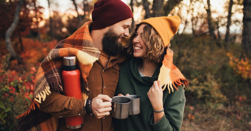 Cozy couple in fall with blankets and low mountain hiking
